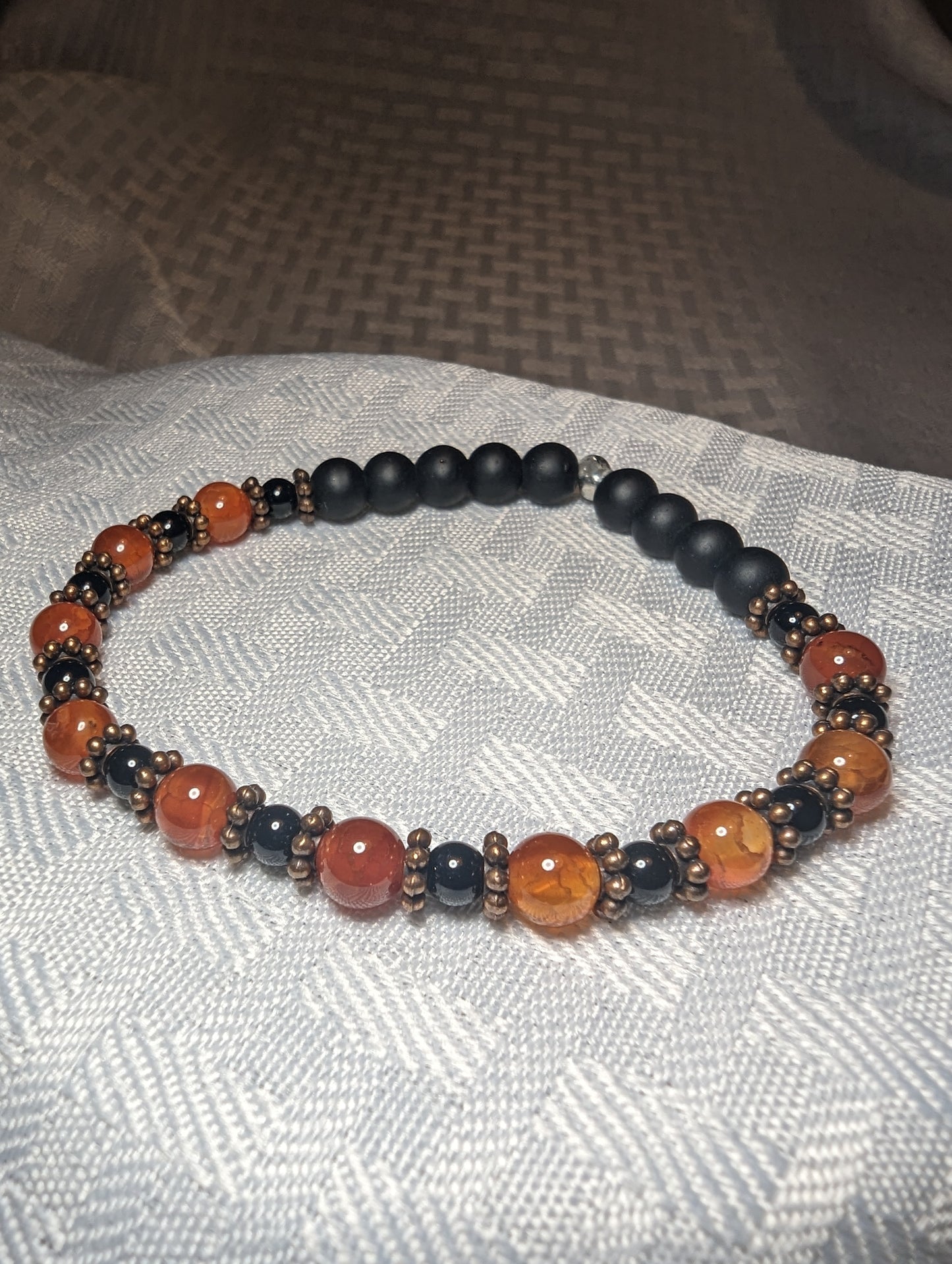 Orange and black glass bead bracelet